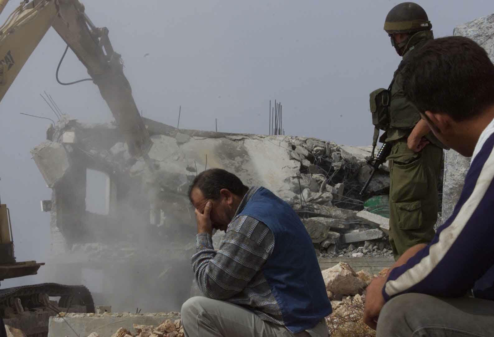 A-Palestinian-man-cant-look-as-his-home-is-demolished